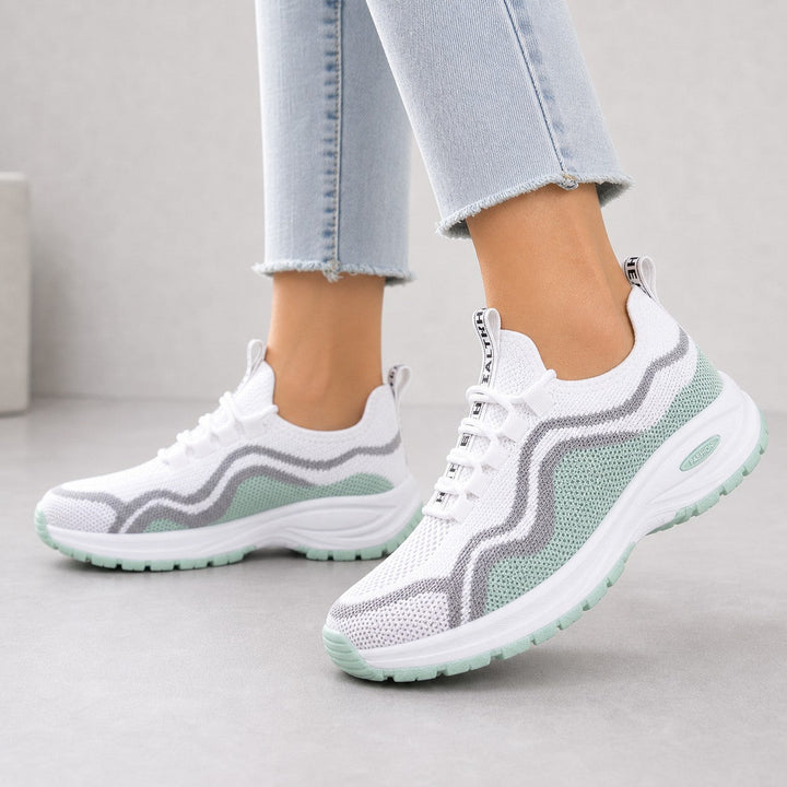 Collection of women's cushioned lace-up walking shoes in various colors for casual footwear.