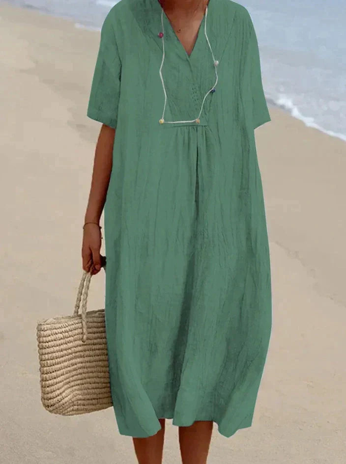 Effortless women's cotton linen V-neck midi dress, A-line silhouette, ideal for summer vacation and beach.