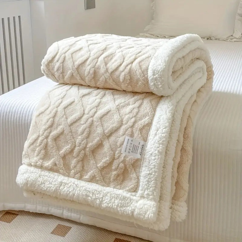 Stylish diamond knit sherpa blanket, offering reversible plush comfort and home decor appeal.