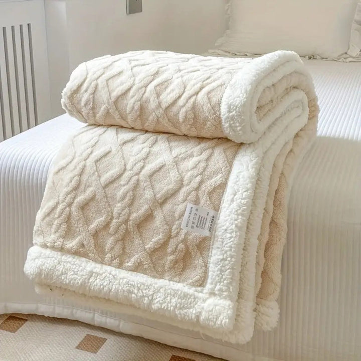 Stylish diamond knit sherpa blanket, offering reversible plush comfort and home decor appeal.
