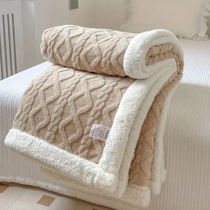 A warm and cozy sherpa throw blanket with a beautiful diamond knit design, perfect gift.