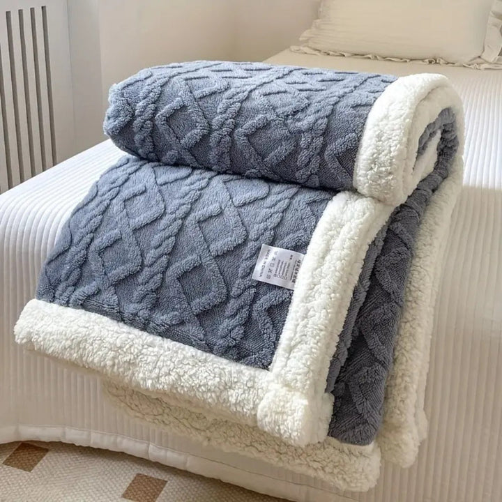 Cuddle up in this plush diamond knit sherpa blanket, designed for all-season coziness.