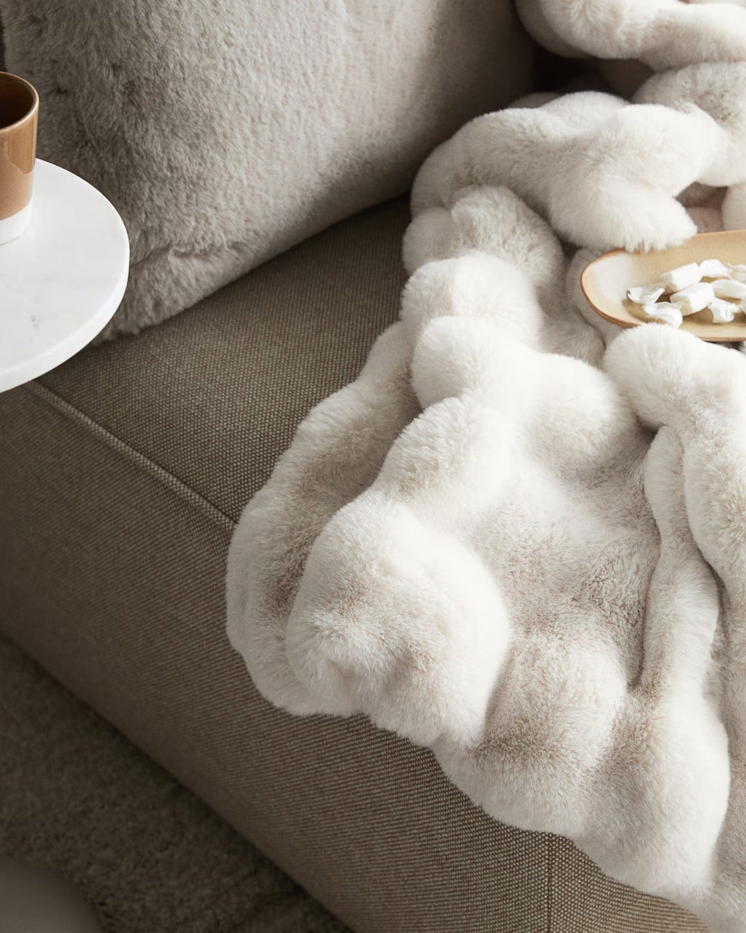 Stylish recycled polyester plaid fleece blanket in white, enhancing living room or bedroom decor.