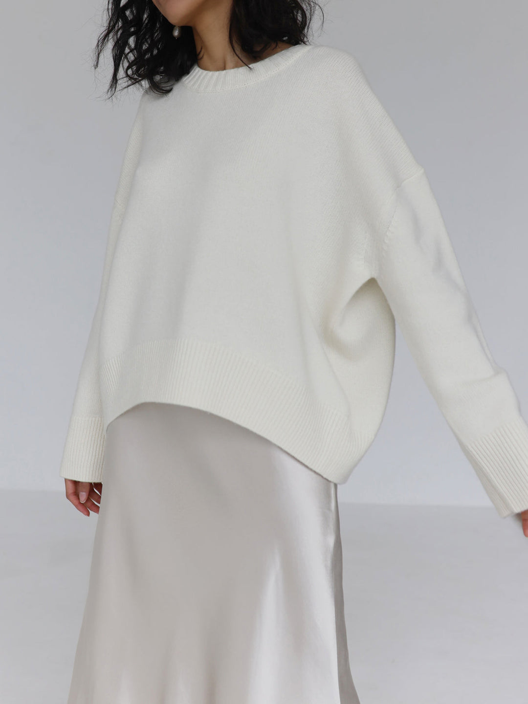 A simple, yet stylish oversized crewneck sweater in a neutral cream color.