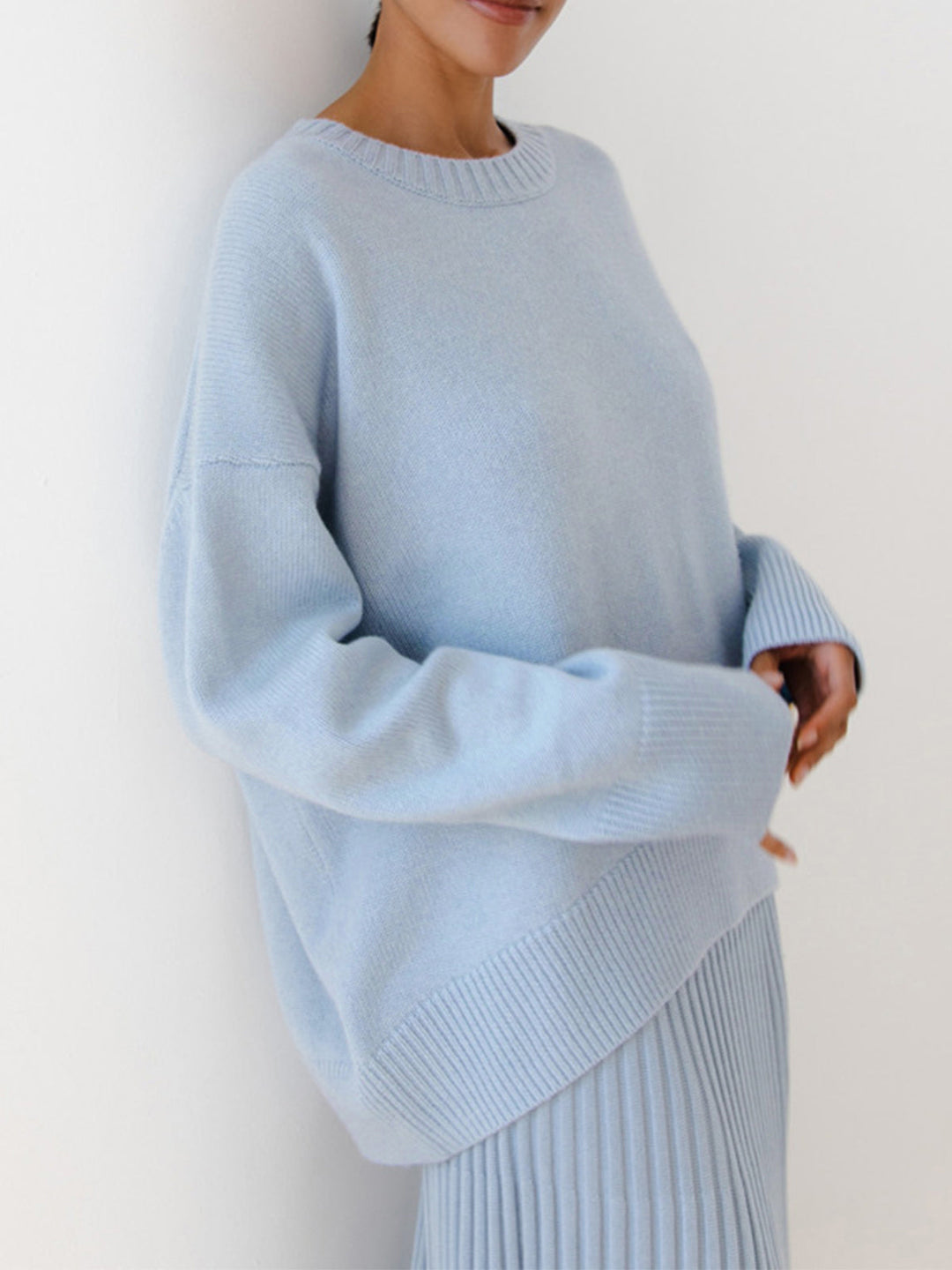 Model wearing a versatile one-size-fit oversized knit sweater, ideal for layering.