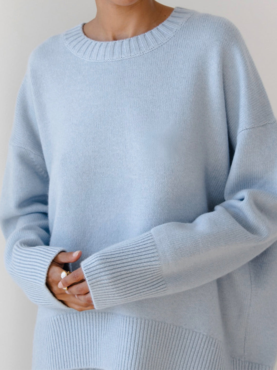 Close-up of the soft texture of an oversized crewneck sweater, highlighting its knit detail.