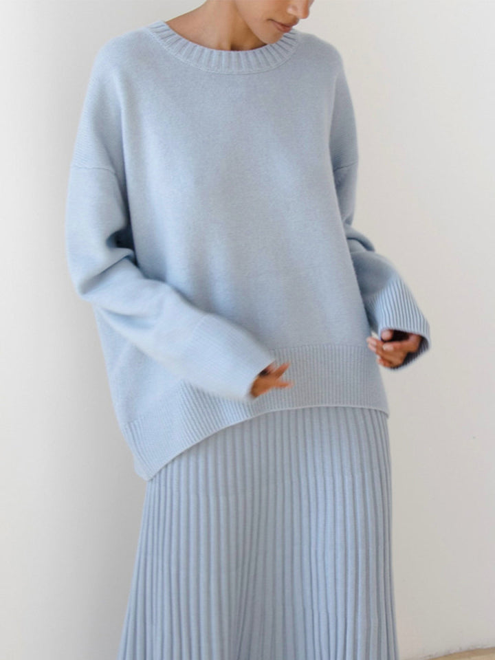 Chic oversized crewneck sweater in a classic grey, styled for a relaxed loungewear look.