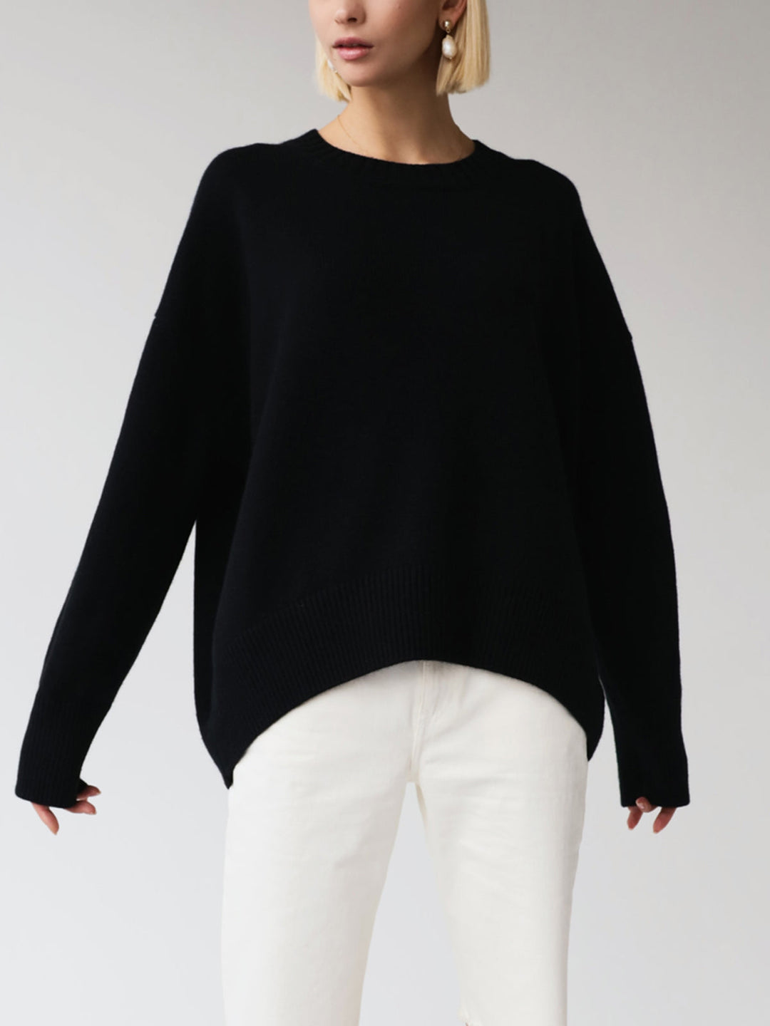 Plush knit fabric of a cozy oversized crewneck sweater, perfect for staying warm.
