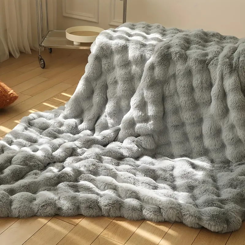 Luxurious plush faux fur throw for ultimate softness and warmth. A stylish decorative blanket for home.