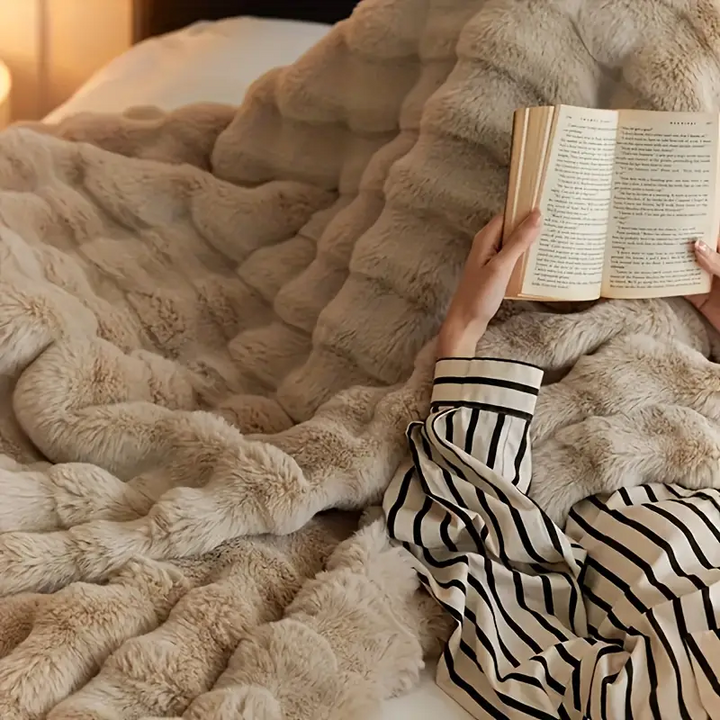 Cozy ultra soft faux fur throw blanket, ideal for adding plush comfort and elegant home decor.