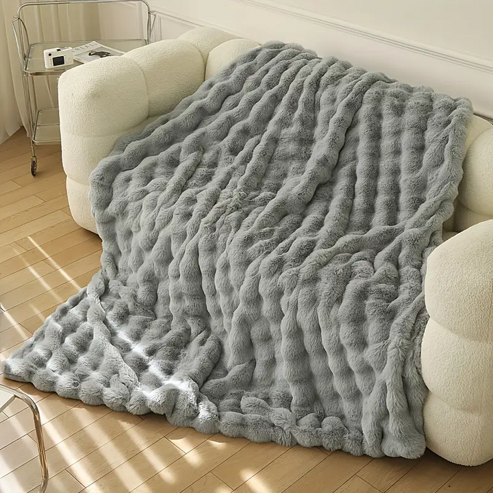 Decorative soft faux fur blanket, perfect for cozy nights. A plush throw adding comfort to your home decor.