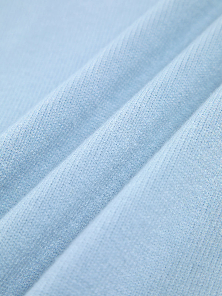 Close-up of a soft, chunky knit women's oversized turtleneck sweater.