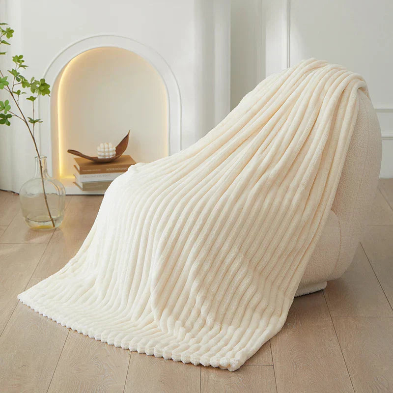 A versatile CozyStripe throw blanket, perfect for living rooms and bedrooms.