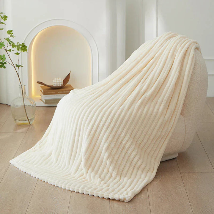 A versatile CozyStripe throw blanket, perfect for living rooms and bedrooms.