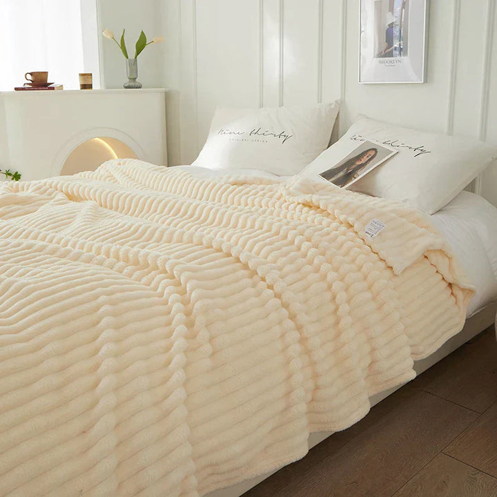 The CozyStripe wide striped blanket adds a touch of warmth and pattern to your decor.