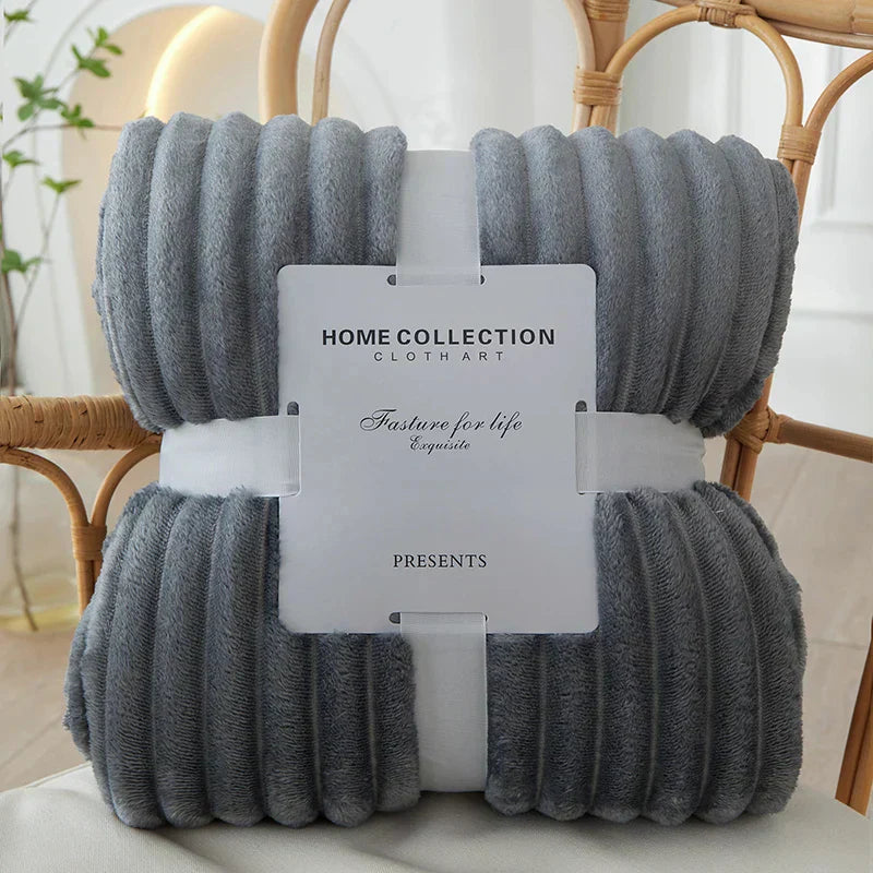 Luxuriously soft CozyStripe flannel blanket with wide stripes, perfect for cold nights.