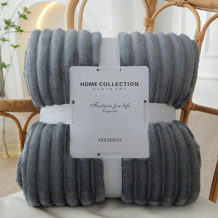Luxuriously soft CozyStripe flannel blanket with wide stripes, perfect for cold nights.