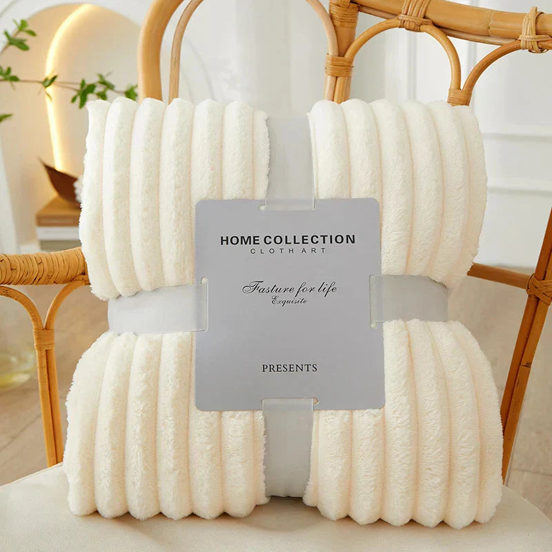 A plush CozyStripe throw blanket made of flannel fleece, featuring bold stripes.