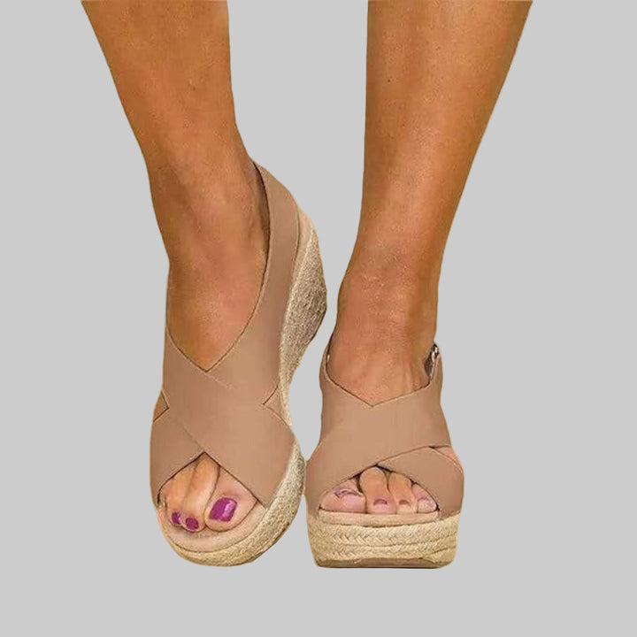 Women's stylish crossed strap wedge espadrilles, perfect for summer casual wear. Comfortable open toe slip-on sandals.