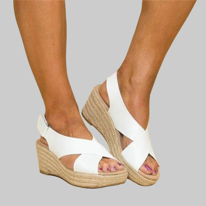 Trendy women's espadrille wedges with crossed straps. Comfortable summer sandals for everyday fashion. Slip-on design.