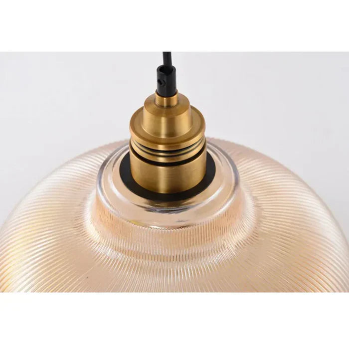 Illuminated CrystalLoom pendant light with transparent glass, enhancing interior space.