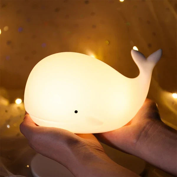 Kids' cute whale night light. This color-changing LED lamp provides soft, ambient light for nurseries.