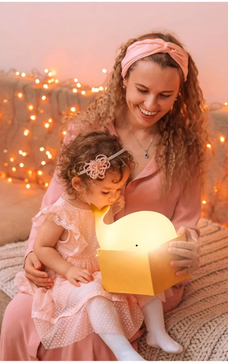 Whimsical color-changing whale night light, a charming bedside lamp & LED sleep aid for children's rooms.