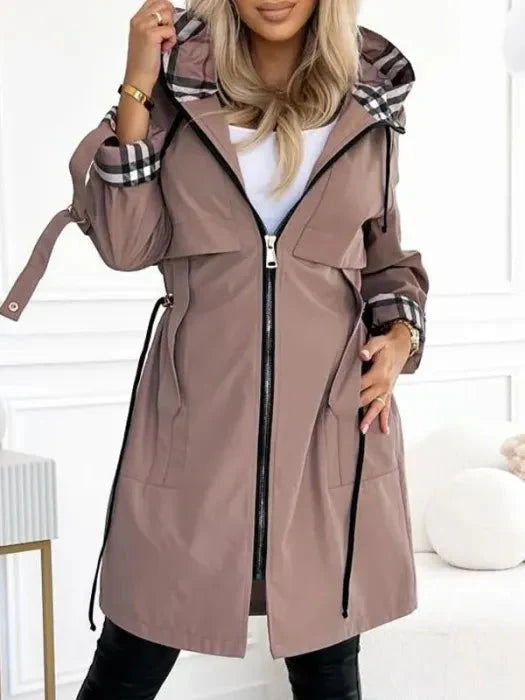 Stylish women's waterproof rain jacket with hood, perfect for all-weather protection & functional everyday wear.