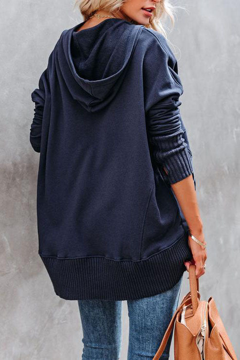 Fashionable women's hooded tunic sweatshirt with a love theme, offering cozy comfort.
