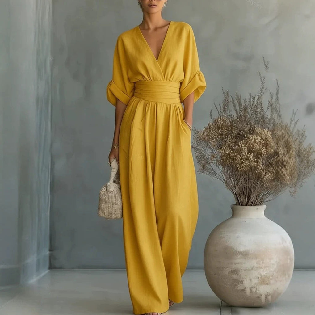Comfortable solid color wide leg jumpsuit for women, featuring a stylish V-neck and short sleeves.