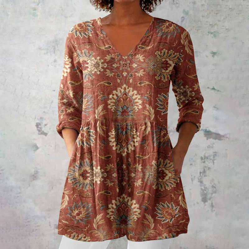 Women's printed V-neck tunic top with 3/4 sleeves. Stylish and comfortable for casual everyday wear.
