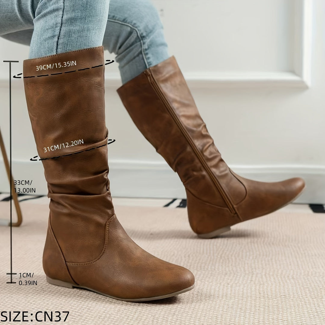Stylish women's gathered knee-high boots with a flat sole, offering comfort and fall fashion appeal.