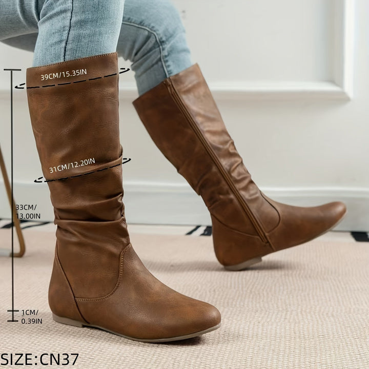 Stylish women's gathered knee-high boots with a flat sole, offering comfort and fall fashion appeal.