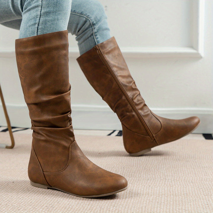 Comfortable flat sole knee-high boots for women, featuring a gathered design, perfect for casual winter wear.