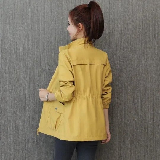 Comfortable women's waterproof jacket with adjustable cinched waist. Essential stylish outerwear for rain.