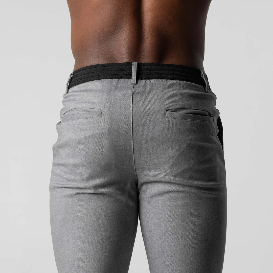 Man walking in navy versatile chino pants, showcasing their comfortable stretch & fit.