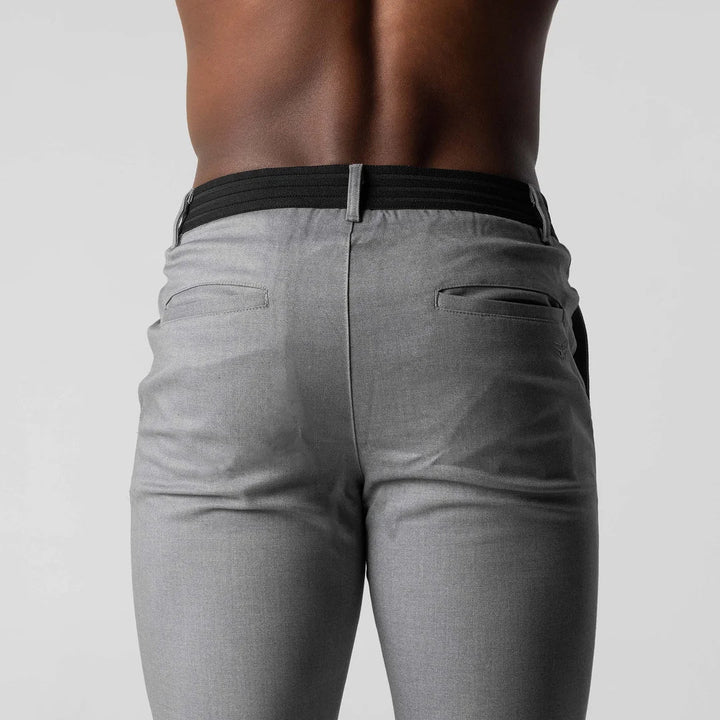Man walking in navy versatile chino pants, showcasing their comfortable stretch & fit.