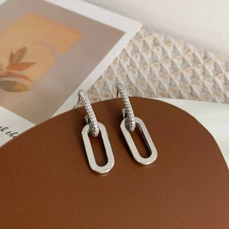 Deluxe women's silver loop earrings, slim design, sparkling cubic zirconia.