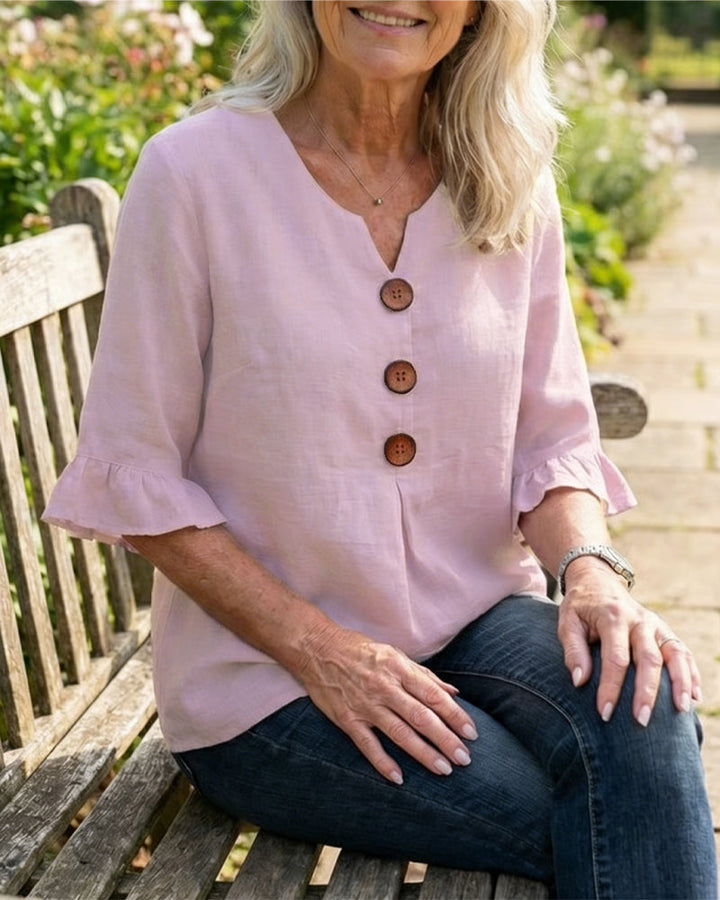 Women's relaxed fit blouse, perfect for summer, featuring ruffle sleeves & button front.
