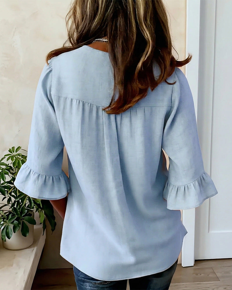 Ladies everyday fashion blouse, buttoned front, v-neckline, & stylish ruffle sleeves.