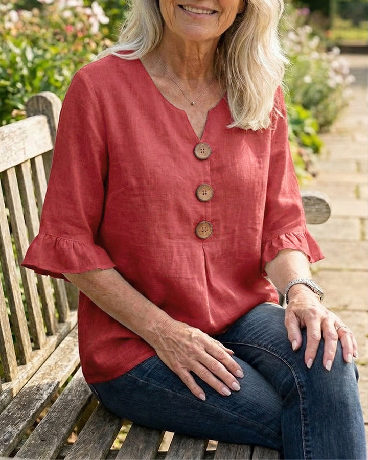 Women's warm weather shirt, relaxed fit, button front closure, and feminine ruffle sleeves.
