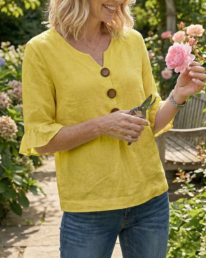 Women's relaxed summer top with charming ruffle sleeves, v-neck, and full button front.