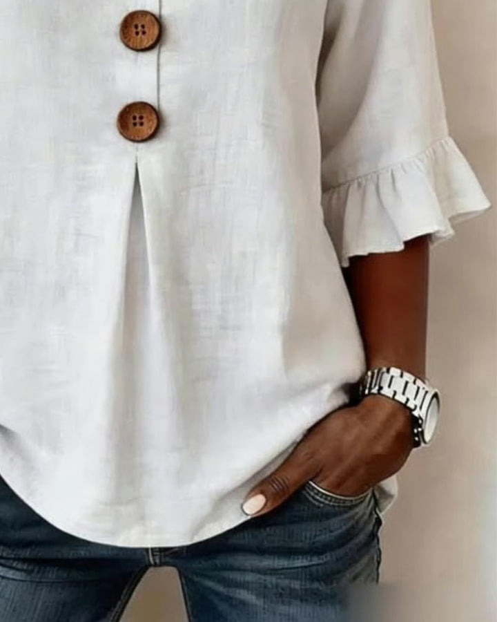 Women's sophisticated blouse with ruffle sleeves, v-neck, & practical button-front style.