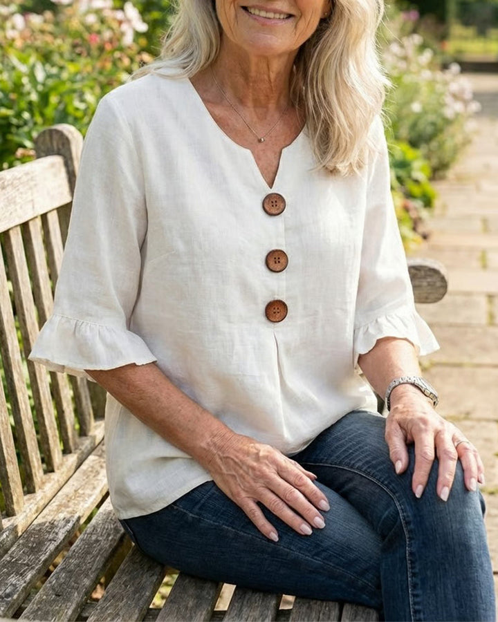 Chic women's casual blouse, button-up design, with flattering v-neck & ruffle sleeves.