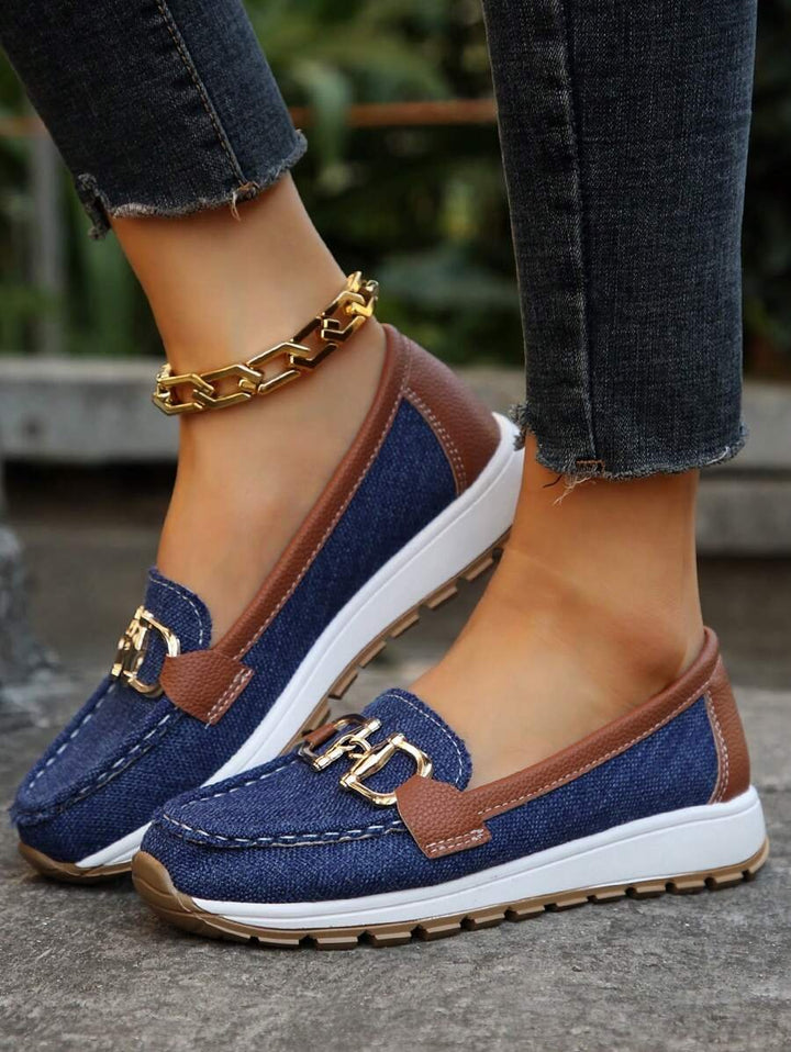 Chic women's orthopedic loafers, slip-on design, prominent gold accent, comfortable & supportive.