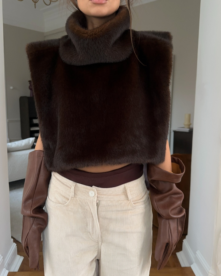 Women's stylish dark brown faux fur turtleneck vest, a cozy sleeveless winter fashion piece.
