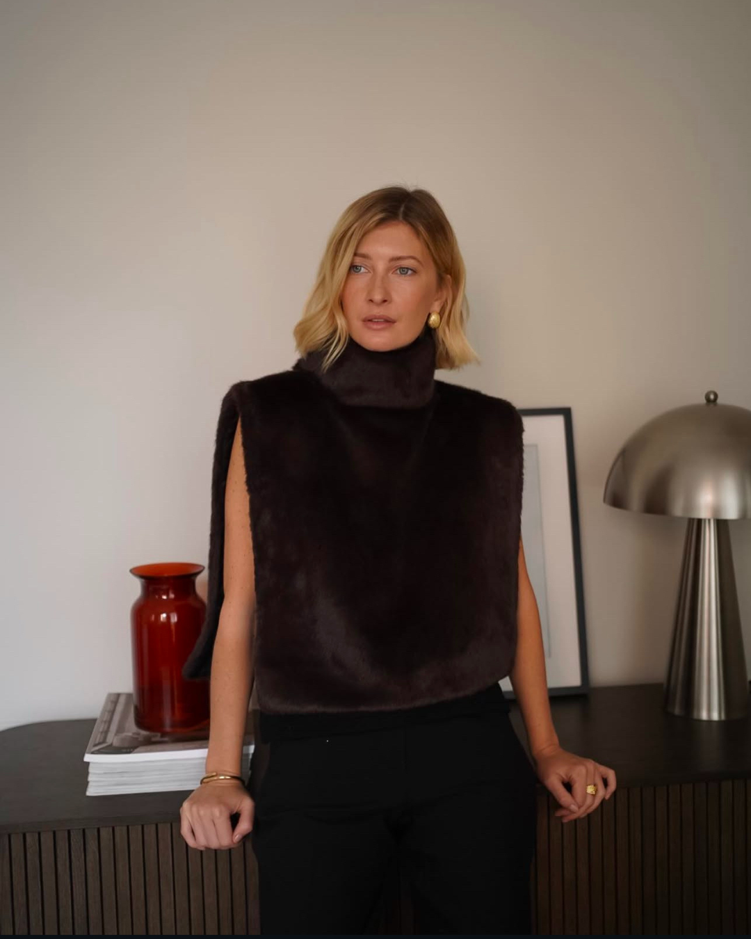 Plush dark brown faux fur women's vest with turtleneck, offering luxurious comfort for winter.