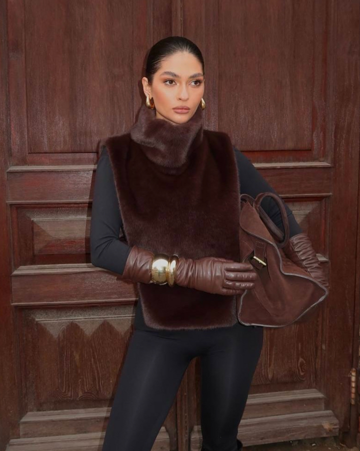 Women's dark brown faux fur turtleneck vest. Luxurious, sleeveless winter fashion outerwear.