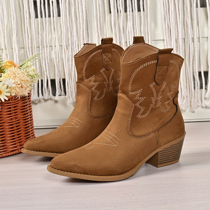 Classic women's wide-calf cowboy boots featuring intricate embroidery, a pointed toe, and sturdy block heel.