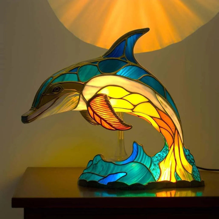 Stained glass effect table lamp showcasing a detailed animal sculpture.